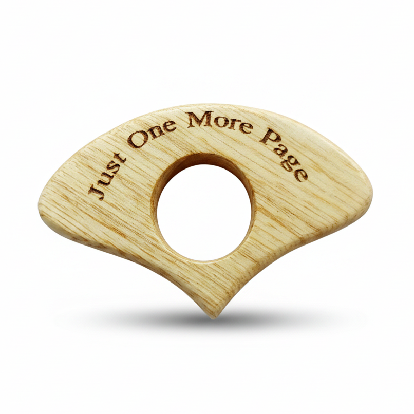 Light wooden book page holder engraved Just One More Page on a white background