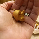 Hand carved little wooden pig. Natural yellow wood